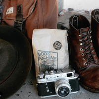 roos machine coffee with camera and travel items
